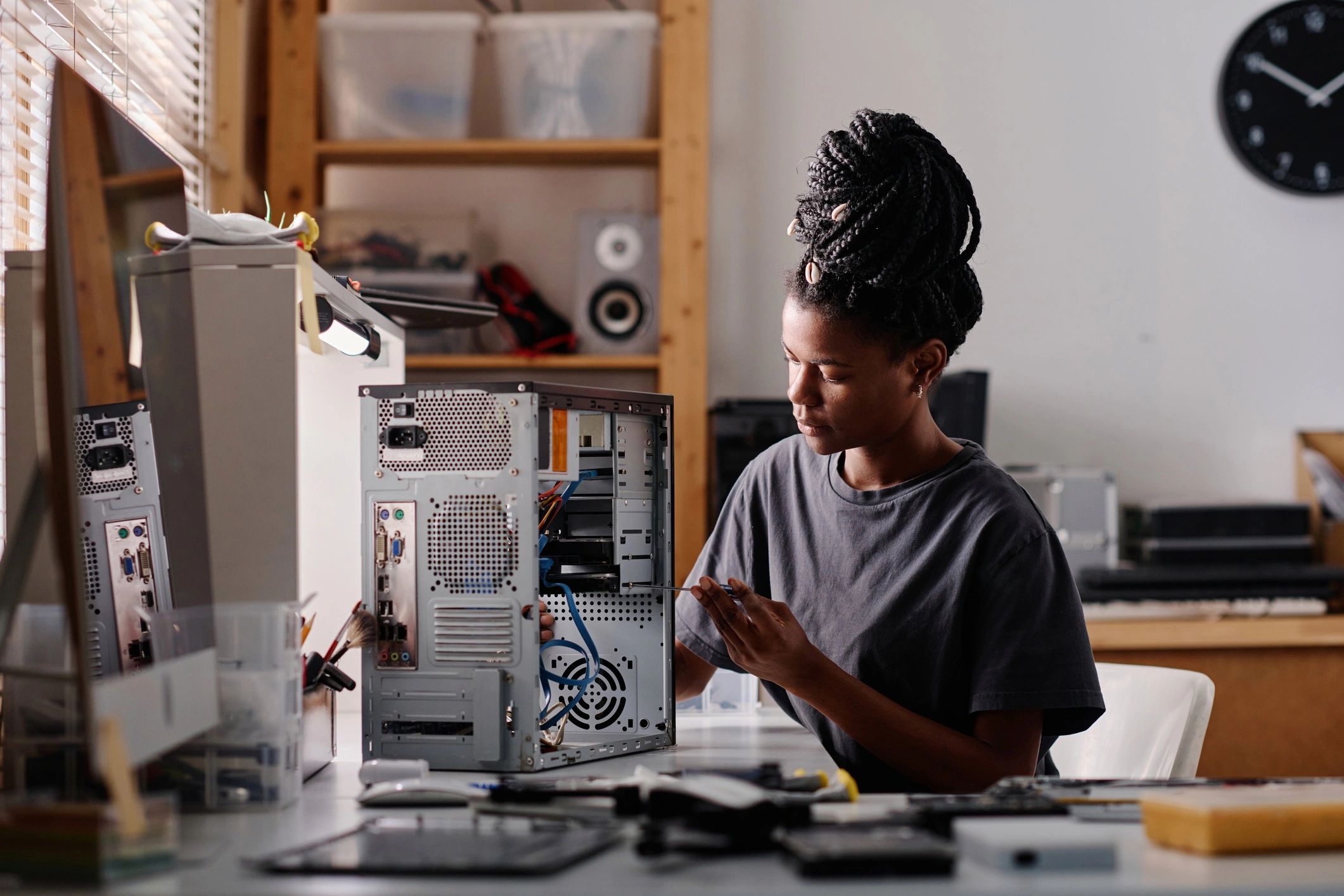Computer technician repairing a desktop PC in a workshop